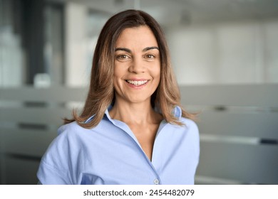 Happy middle aged business woman attorney, smiling 45 years old lady entrepreneur, mature female professional executive manager leader standing in office looking at camera. Headshot portrait. - Powered by Shutterstock