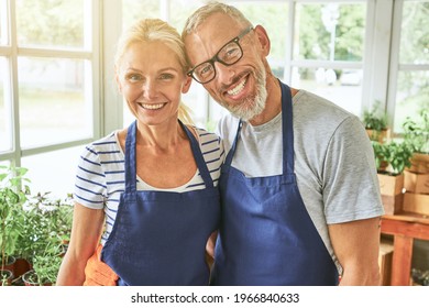 Happy Middle Aged Caucasian Couple In Garden House