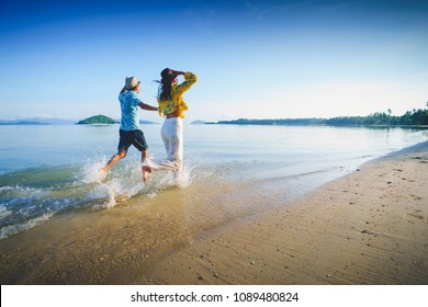 Happy Middle Aged Couple Running On A Beach, Koh Mak Thailand