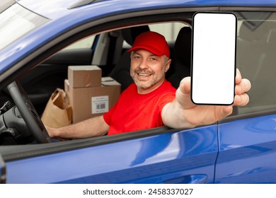 Happy middle aged courier man showing cellphone with empty screen, advertising delivery service, sitting in van and smiling, mockup - Powered by Shutterstock