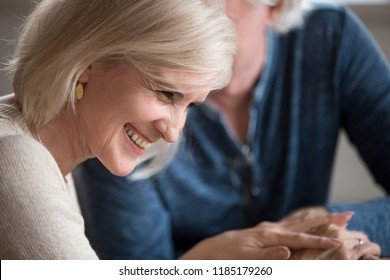 Happy Middle Aged Senior Woman With Beautiful Face Laughing Flirting With Beloved Older Man, Smiling Loving Wife Enjoying Humor Talk With Elderly Husband, Mature Family Couple Having Fun On Date