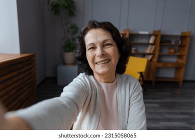 Happy middle aged senior woman talk on video call with friends family. Laughing mature old senior grandmother having fun speaking with grown up children online, Headshot portrait selfie webcamera view - Powered by Shutterstock