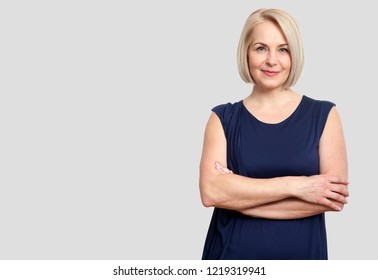 Happy middle aged woman isolated on grey background