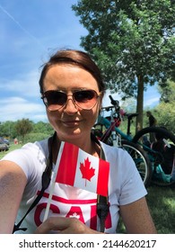 Happy Middle Aged Woman Taking Selfie Holding Canadian Flag On Canada Day