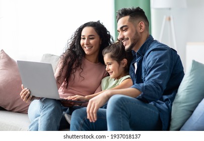 Happy Middle Eastern Family Of Three Using Laptop Together At Home