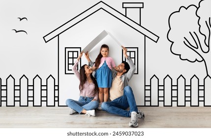 Happy middle eastern family of three father mother and daughter sitting on floor over illustrated house of their dreams over white wall background, parents holding a roof - Powered by Shutterstock