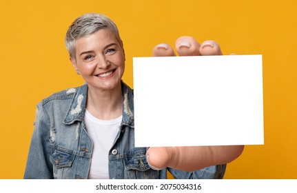 Happy Middle-Aged Short-Haired Woma Holding Blank White Card For Advertisement, Posing Smiling Looking At Camera Standing In Studio Over Yellow Background, Showing Good Offer, Collage, Panorama