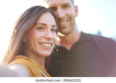 Happy Millenial Couple Taking Selfie Outdoors