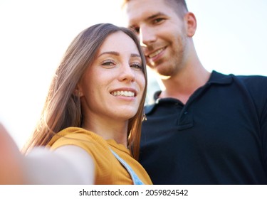 Happy Millenial Couple Taking Selfie Outdoors