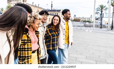 Happy Millenial Friends Having Fun Walking In City Center - Multicultural Group Of Young People Hanging Out Smiling And Laughing Together - Different Students On Travel Vacation Outside 