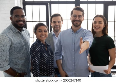 Happy Millennial Business Group Leader Giving Hand For Shake. Photo Portrait Of Diverse Professional Team Welcoming Employees For Hire And Job. Lawyers Or Brokers Offer Deal To Clients And Customers