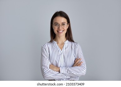 Happy millennial business woman in glasses posing with hands folded isolated on white, looking at camera, smiling. Confident female customer, young student girl, professional head shot portrait - Shutterstock ID 2103373409