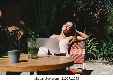 Happy millennial copywriter smiling during remote work - enjoying digital nomad, happy Caucaisan hipster girl with modern netbook computer keeping freelance lifestyle - technology and communication