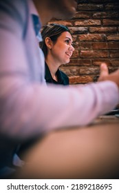 Happy Millennial Couple Listens Carefully To Their Financial Consultant Over A Coffee Meeting