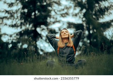 
Happy Millennial Woman Relaxing in the Grass Enjoying Nature. Carefree adult girl feeling disconnected from stress and urban life 
 - Shutterstock ID 2336355779