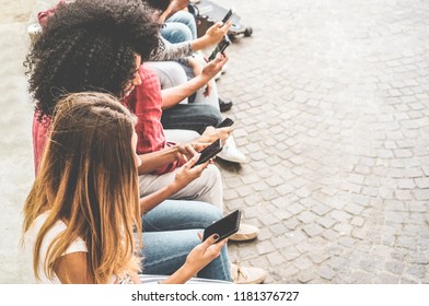 Happy millennials friends surfing online with mobile phones - Young people using smartphone outdoor - Youth lifestyle, generation z and technology trend concept - Focus on bottom hand cellphone - Shutterstock ID 1181376727
