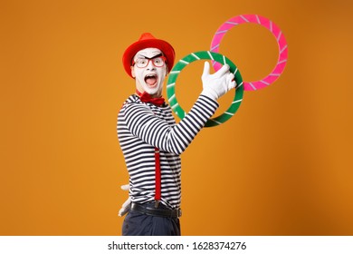 Happy mime clown with multi-colored rings on orange background