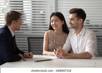 Happy Mixed Ethnicity Couple Customers Talk To Lawyer Bank Manager At Meeting Consulting About Investment Insurance Real Estate Deal, Young Family Clients Listen To Broker Insurer Explaining Benefits