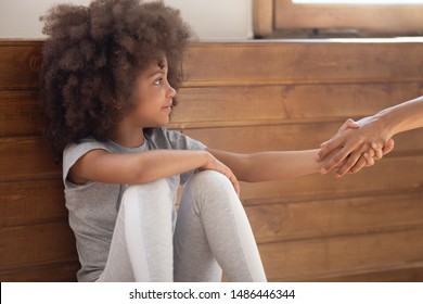 Happy Mixed Race Adorable Little Girl Holding Lent Hand, Accepting Psychological Help Or Forgiving Offense. Orphan Cute Child Holding Hand Of Foster Parent, New Adopting Family, Charity Concept.