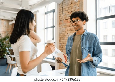 Happy mixed race colleagues partners students classmates workers managers having small talk while coffee break in office, discussion work study start up project. Business college education concept - Powered by Shutterstock