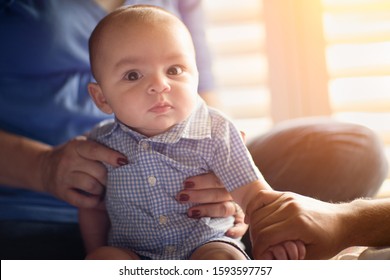 Happy Mixed Race Couple Enjoying Their Newborn Son In The Light of The Window.