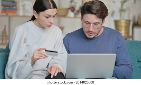 Happy Mixed Race Couple Excited After Shopping Online With Laptop At Home 