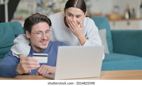 Happy Mixed Race Couple Shopping Online On Laptop At Home 