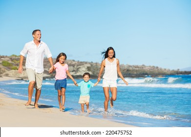 Happy Mixed Race Family Of Four On The Beach