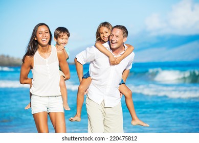 Happy Mixed Race Family Of Four On The Beach