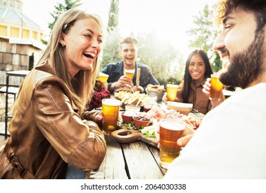 Happy Mixed Race Family Having Dinner Together Outdoor - Young People Having Fun On The Terrace Drinking Beers And Chatting - Multicultural Friends Celebrating Backyard Home Party - Friendship Concept