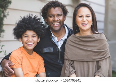 Happy Mixed Race Family Laughing And Smiling.