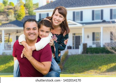 Happy Mixed Race Family Portrait In Front of Their House.