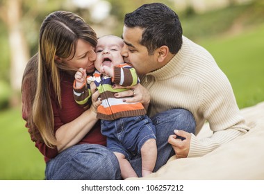 Happy Mixed Race Parents Playing with Their Giggling Son.