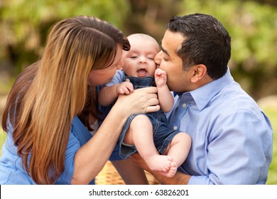 Happy Mixed Race Parents Playing with Their Giggling Son.