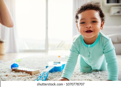 Happy Mixed Race Toddler Boy Crawling In Sitting Room