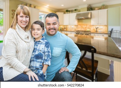 Happy Mixed Race Young Family Inside Beautiful Kitchen Of Their House.