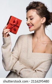 Happy Model In Cozy Sweater Holding Red Gift Box Isolated On White