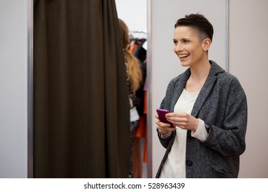 Happy Model With Phone At Fashion Week Backstage. Soft Focus Photo Taken At Wide Open Aperture.