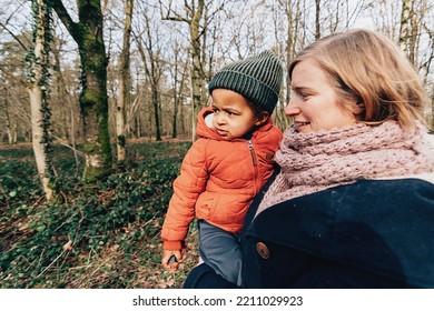 Happy Mom With Baby On Walk Outdoors In Nature