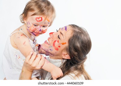 Happy Mom And Baby Playing With Painted Face By Paint. Games With Child Affect Early Development. Important To Spend Enough Time With Your Kids.