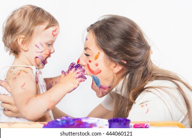 Happy Mom And Baby Playing With Painted Face By Paint. Games With Child Affect Early Development. Important To Spend Enough Time With Your Kids.