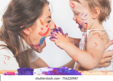 Happy Mom And Baby Playing With Painted Face By Paint. Mother Day. Games With Child Affect Early Development. Important To Spend Enough Time With Your Kids.