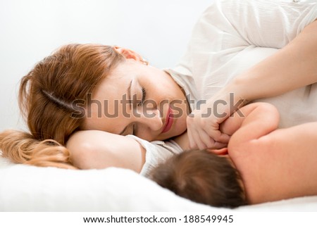 happy mom breast feeding newborn baby