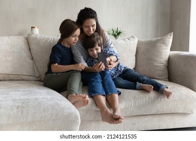 Happy Mom And Cheerful Gen Z Kids Using Digital Gadget On Couch, Making Video Call, Taking Selfie On Smartphone, Taking Selfie, Looking At Mobile Phone Screen, Smiling, Laughing, Having Fun