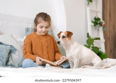 Happy mom and daughter play with their adorable wired Jack Russell Terrier puppy at home. Loving family with a puppy in the bedroom. Background, close-up, copy space. - Shutterstock ID 2279504597