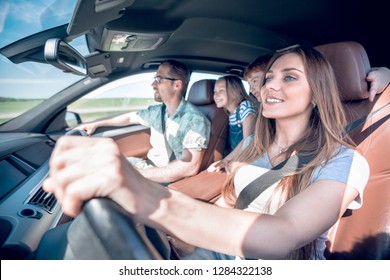 Happy Mom Driving A Family Car