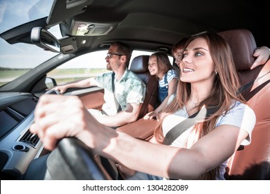 Happy Mom Driving A Family Car
