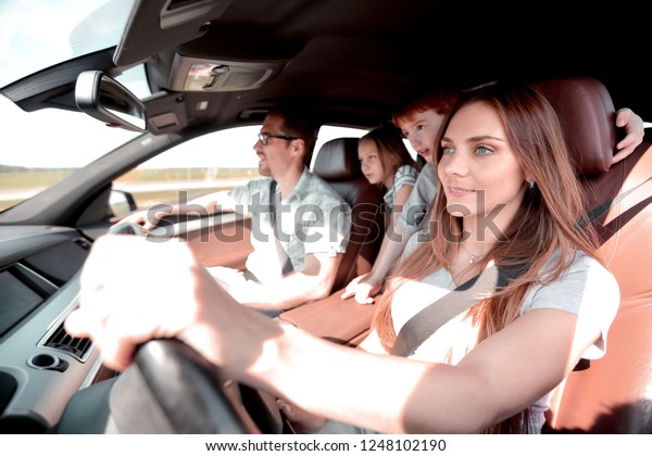 happy mom driving a family\
car