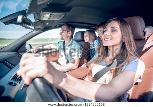 happy mom driving a family
car