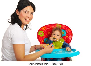 Happy Mom Feeding Her Baby Boy With Vegetables Puree